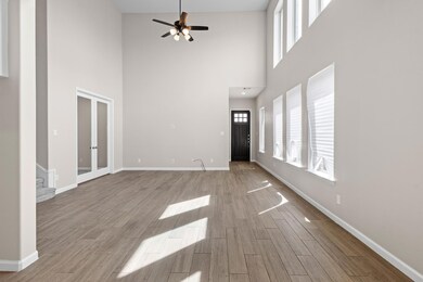 Unfurnished living room with french doors, stairwa