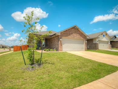 Single story home with an attached garage, concrete driveway, brick siding, and a shingled roof