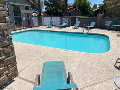 Community pool with a patio