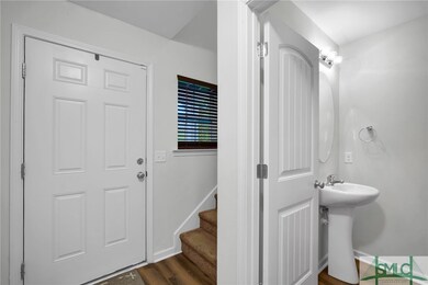 Foyer Entrance w/ side stairs & Powder Room