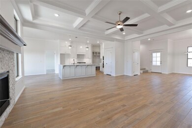 Unfurnished living room featuring beamed ceiling, 