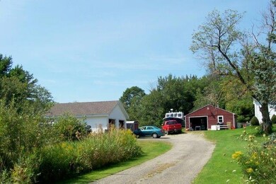 Driveway with 2-car garage to left...