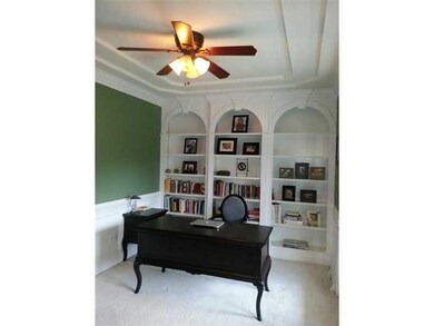 Den. Den with built-in shelving and French doors t