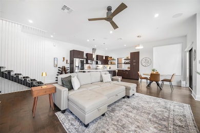 Living room with ceiling fan and dark hardwood flo