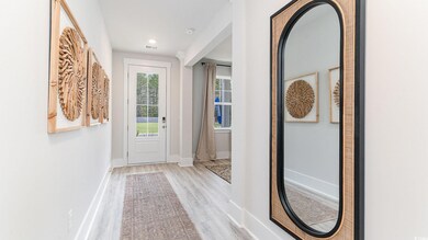 Entryway featuring wood finished floors, baseboards, and recessed lighting