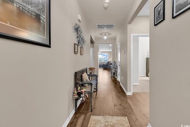 Corridor with wood finished floors and baseboards