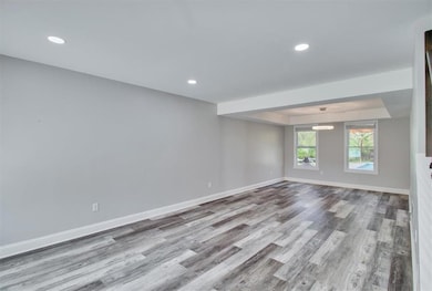 Empty room with recessed lighting, a tray ceiling,