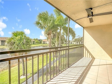 Balcony with a water view, a sunroom, and a ceiling fan