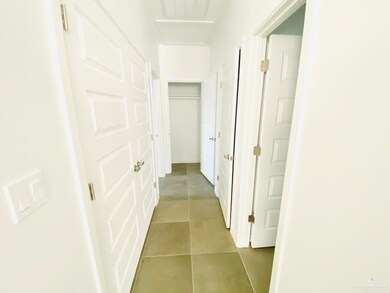 Hallway featuring light tile patterned flooring