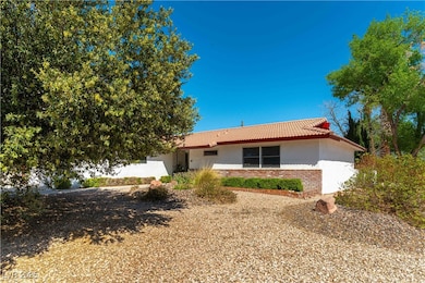 Ranch-style home with brick siding, stucco siding,
