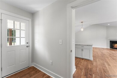 Entryway featuring light wood-style floors, a warm