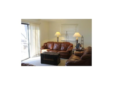 Relax in the large, carpeted family room with pati