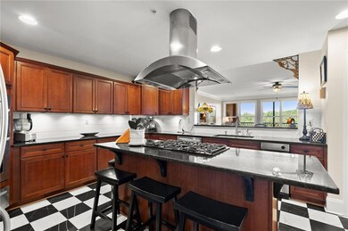 Kitchen featuring light floors, island exhaust hood, a sink, a ceiling fan, and recessed lighting