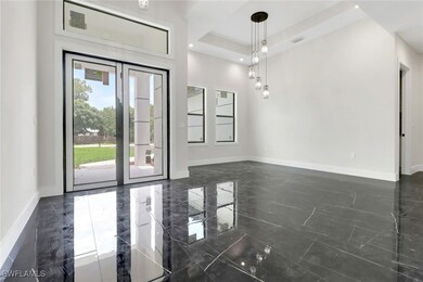 Foyer with glass entry doors and dining area with