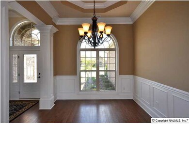 FORMAL DINING AREA BOASTS GORGEOUS TREYED CEILING AND IS HIGHLIGHTED BY THE GORGEOUS MOULDINGS AND HARDWOODS THAT CONTINUE THROUGHOUT THE HOME