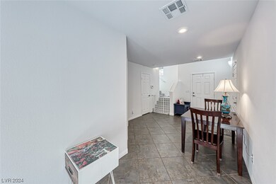 Foyer with access to the garage and upstairs.