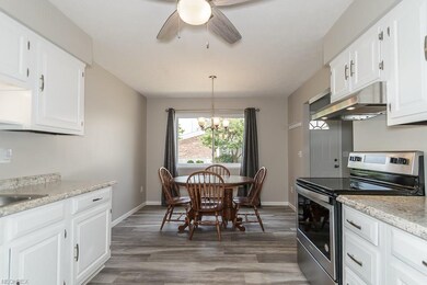 Spacious eat-in kitchen with new chandelier.