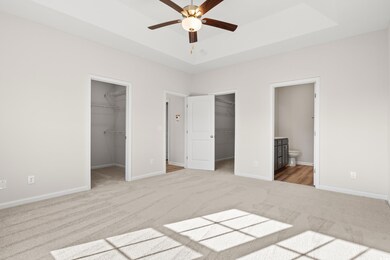 Unfurnished bedroom featuring a walk in closet, en
