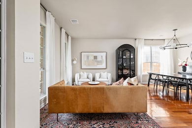 Living area featuring a chandelier, hardwood / wo