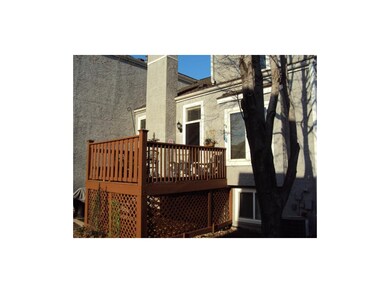 Deck and back yard with large trees.