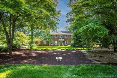 Canopy of trees compliment this home