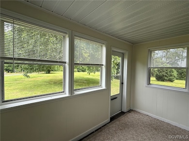 Property entrance through sunroom with plenty of n