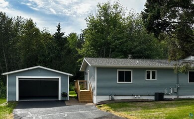 View of front of property featuring a garage, an o