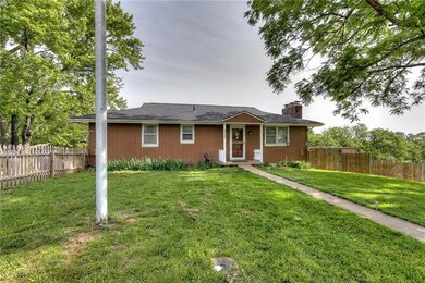 The front of the home.  There is a picket fence ar