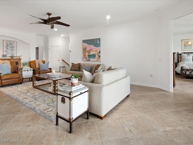 Living area featuring crown molding, light tile patterned floors, recessed lighting, and ceiling fan