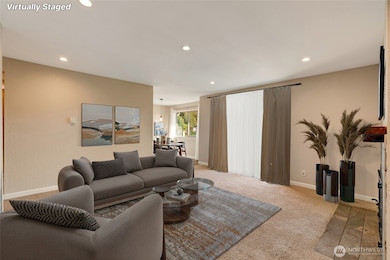 Well lit living room with recessed lighting gives a modern, open feel.