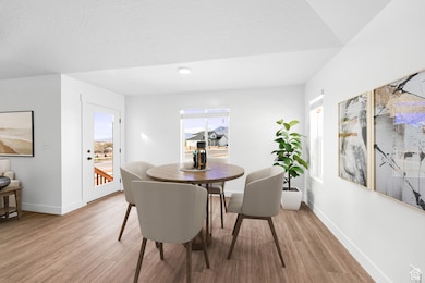 Dining space featuring light wood finished floors and baseboards