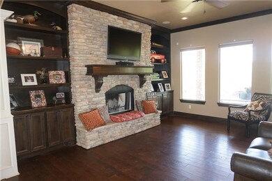 Front living room with stone fireplace, built-in b