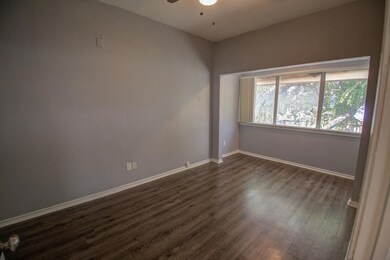 Spare room featuring dark wood-type flooring, cei