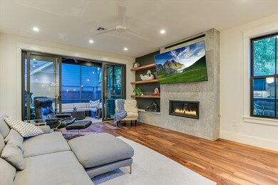 Living room featuring wood finished floors, a cei