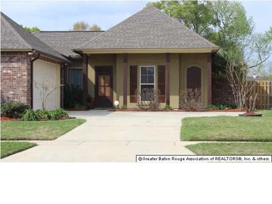 Front of home with landscaping and sprinkler syste