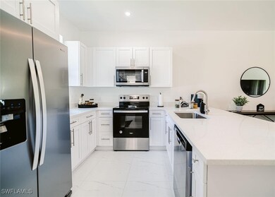 Kitchen featuring kitchen peninsula, sink, applian