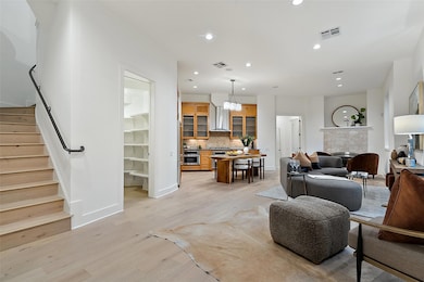 Living area with stairway, recessed lighting, vis