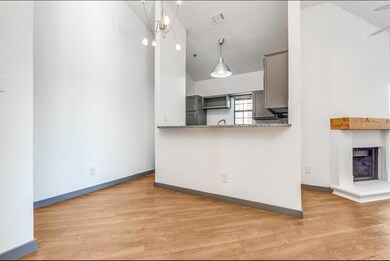 Kitchen with hanging light fixtures, a textured ce