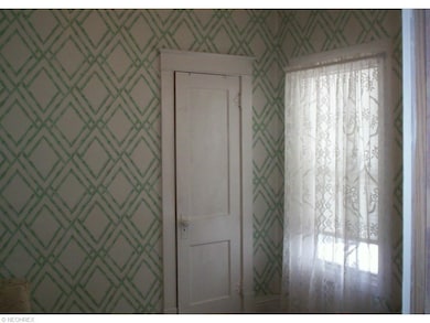 Bedroom two has a hardwood floor.