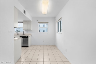 Kitchen featuring dishwasher, light countertops, a