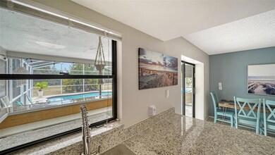 The kitchen pass-through overlooks the lanai and pool