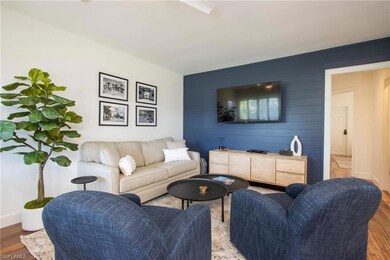 Living room with light wood-style flooring and baseboards