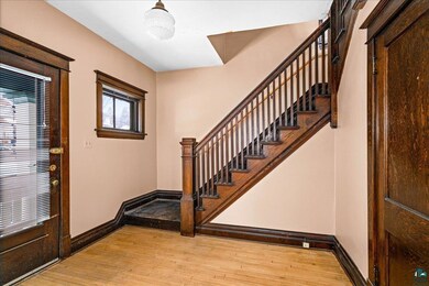Foyer entrance with light wood-type flooring