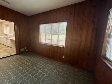 Spare room featuring wood walls and a sink