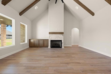 Unfurnished living room featuring high vaulted cei