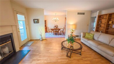 Living Room w/ fireplace and access to walkout pat
