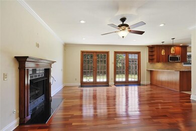 Den is spacious with french doors accessing the re