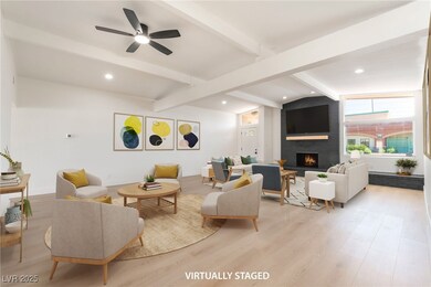 Living area featuring a brick fireplace, light woo