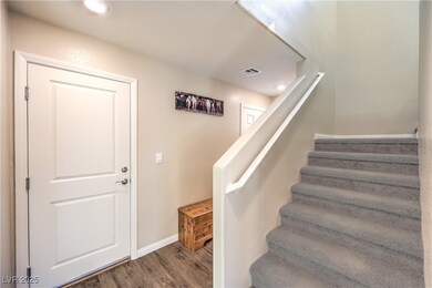Staircase with wood finished floors and baseboards