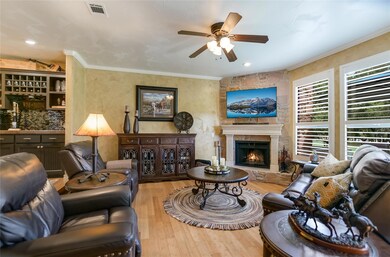 Living area with wood finished floors, ceiling fa